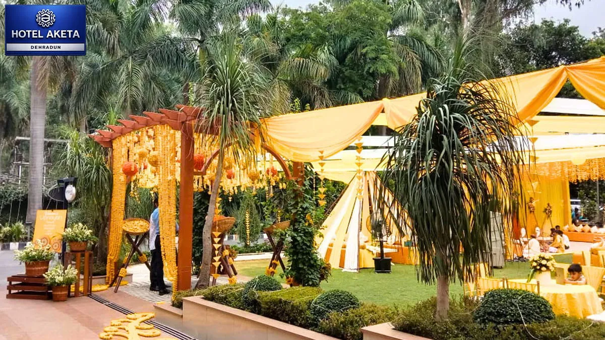 Outdoor lawn set up for a haldi — colourful decor, string lights & guests enjoying- Hotel Aketa